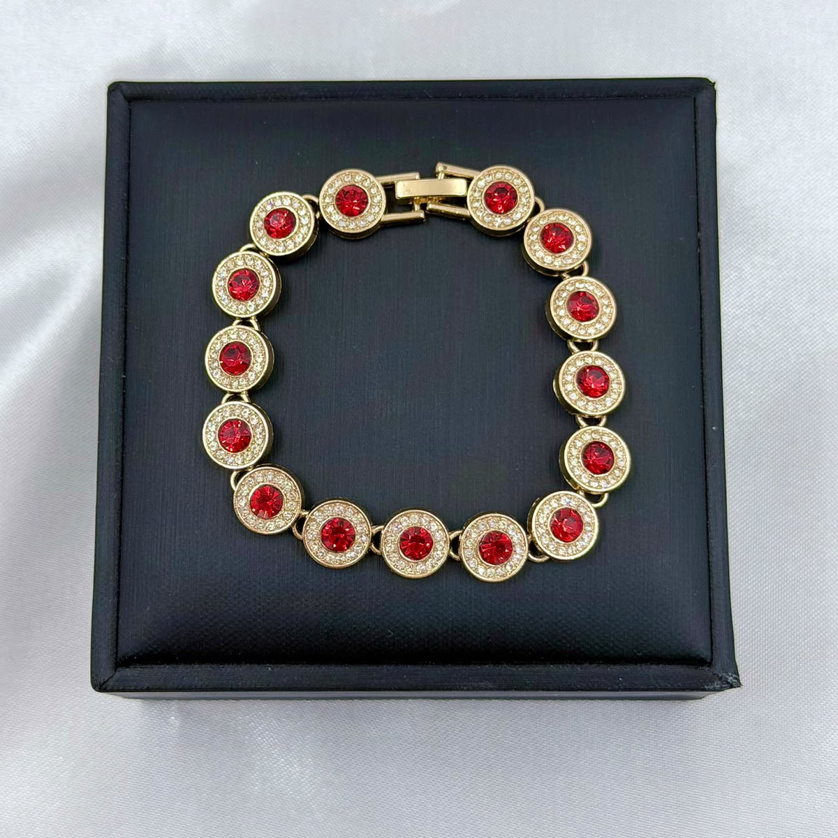 PULSERA RODIO ROJO CIRCON REDONDO CENTRO DORADO