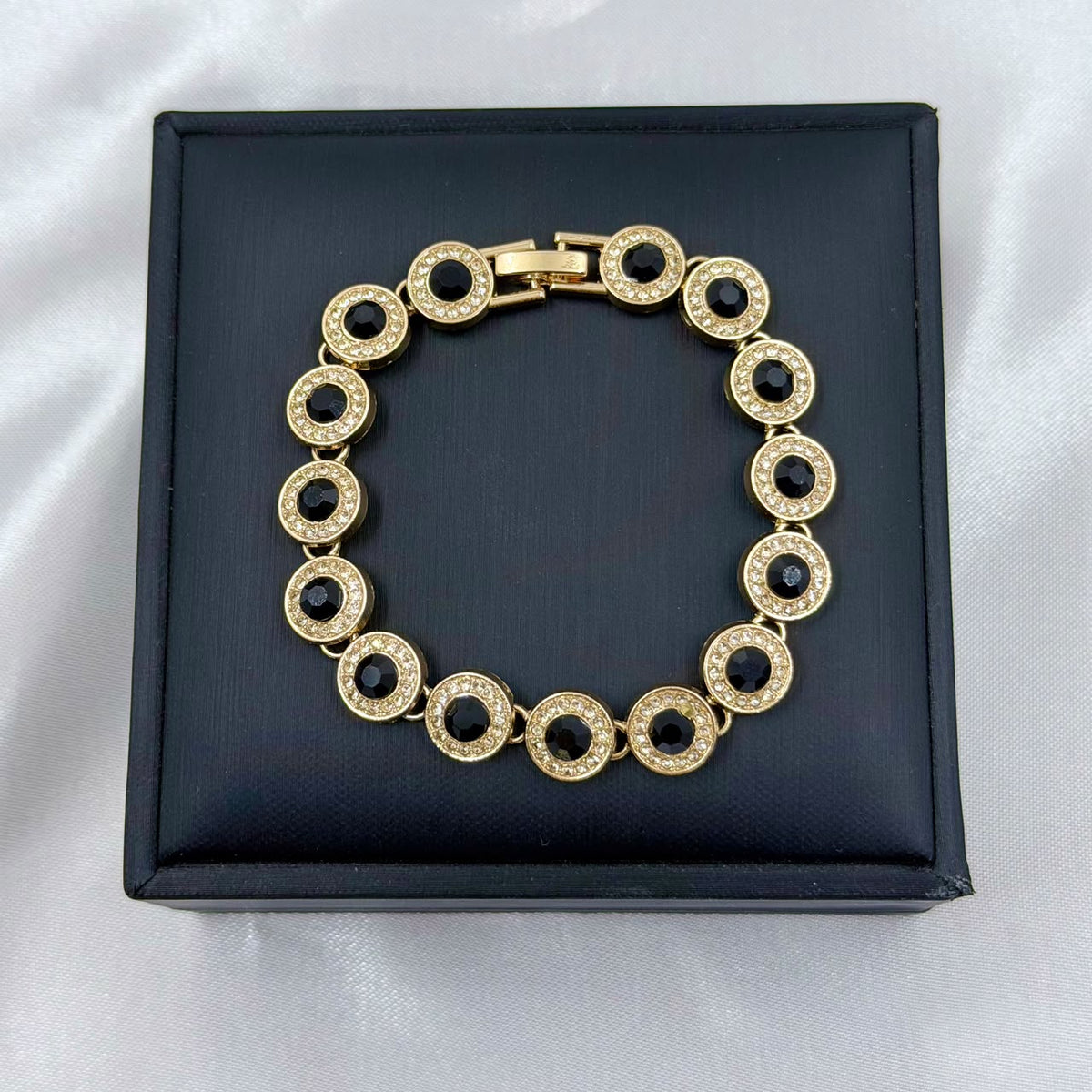 PULSERA RODIO NEGRO CIRCON REDONDO DORADO