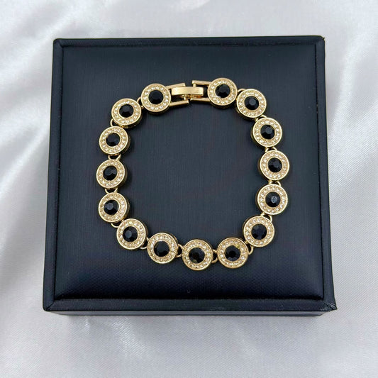 PULSERA RODIO NEGRO CIRCON REDONDO DORADO