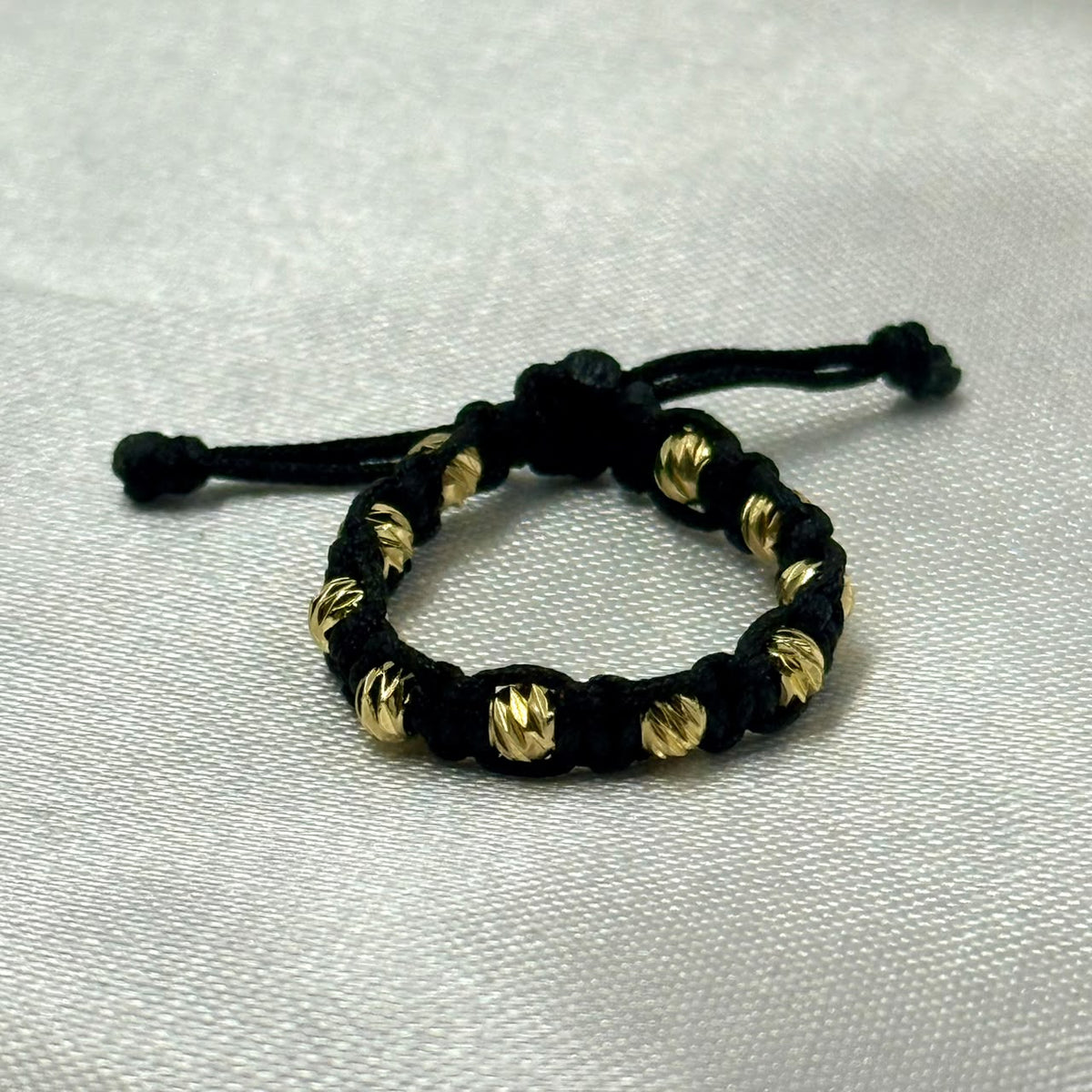 ANILLO RODIO TEJIDO NEGRO DIAMANTADO DORADO